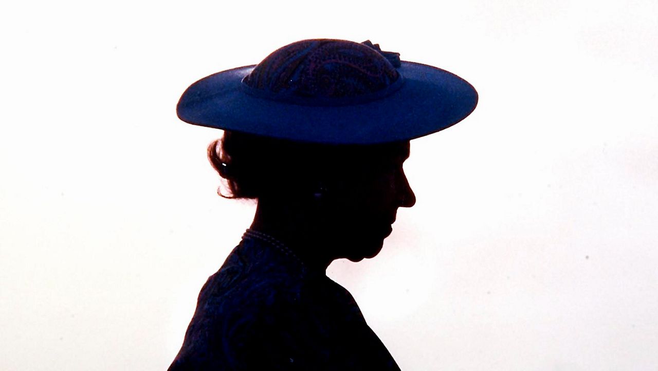 Britain's Queen Elizabeth II is silhouetted during welcoming ceremonies at the airport in Barbados around March 8, 1989. Queen Elizabeth II, Britain’s longest-reigning monarch, has died. She was 96. (AP Photo/Peter Bregg, File)