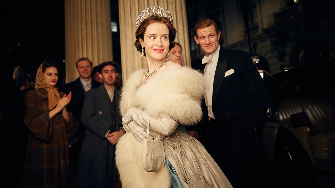 This image released by Netflix shows Claire Foy, center, and Matt Smith, right, in a scene from "The Crown." (Robert Viglasky/Netflix via AP)