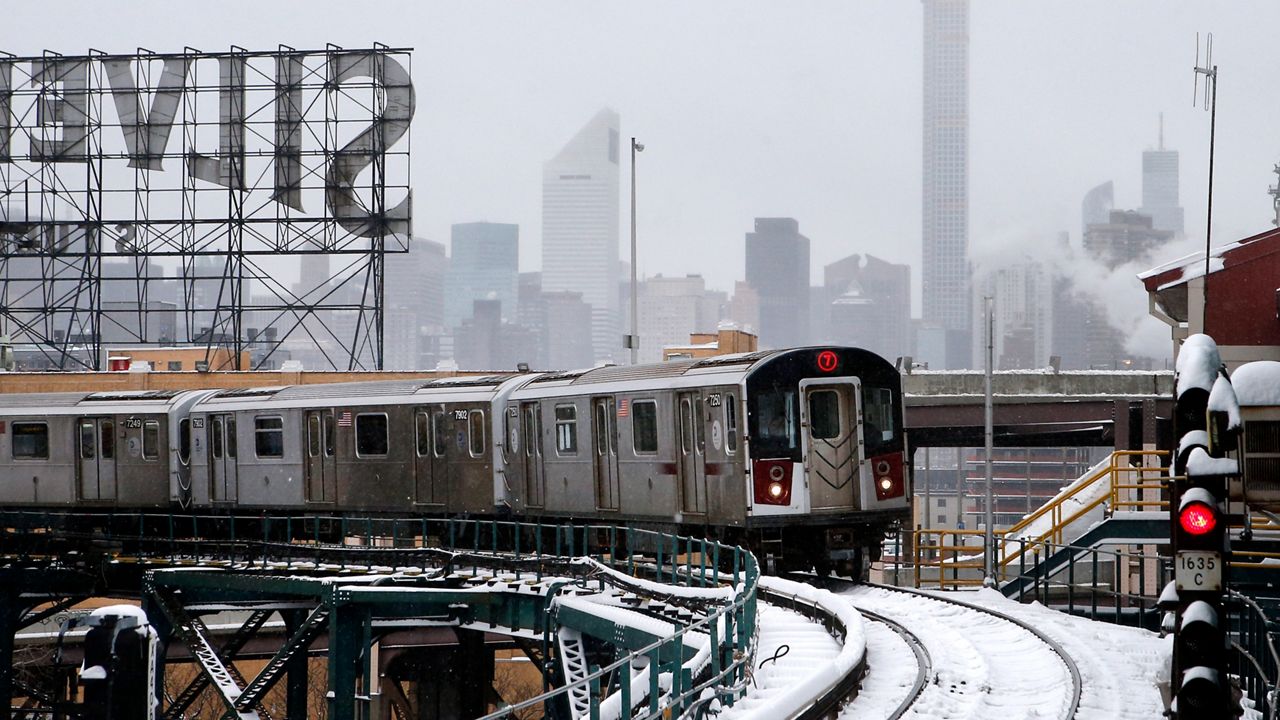 Part of the Manhattan skyline can be seen as a Flushing-bound 7 train arrives at Queensboro Plaza station on Tuesday, Jan. 27, 2015.
