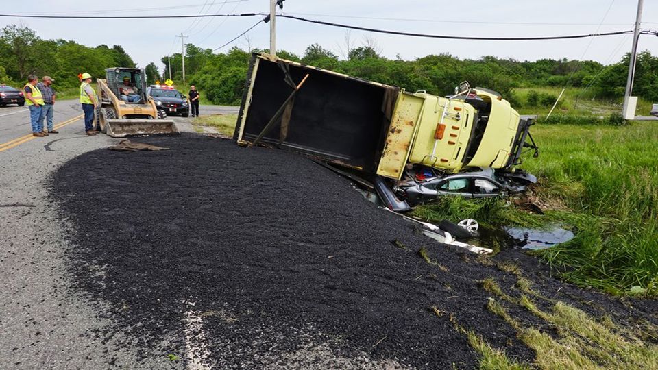 4 Hospitalized After Dump Truck Rolls Over on Car