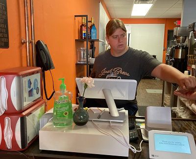 Rachel Travis working the cash register at Just Coffee Coffee House.