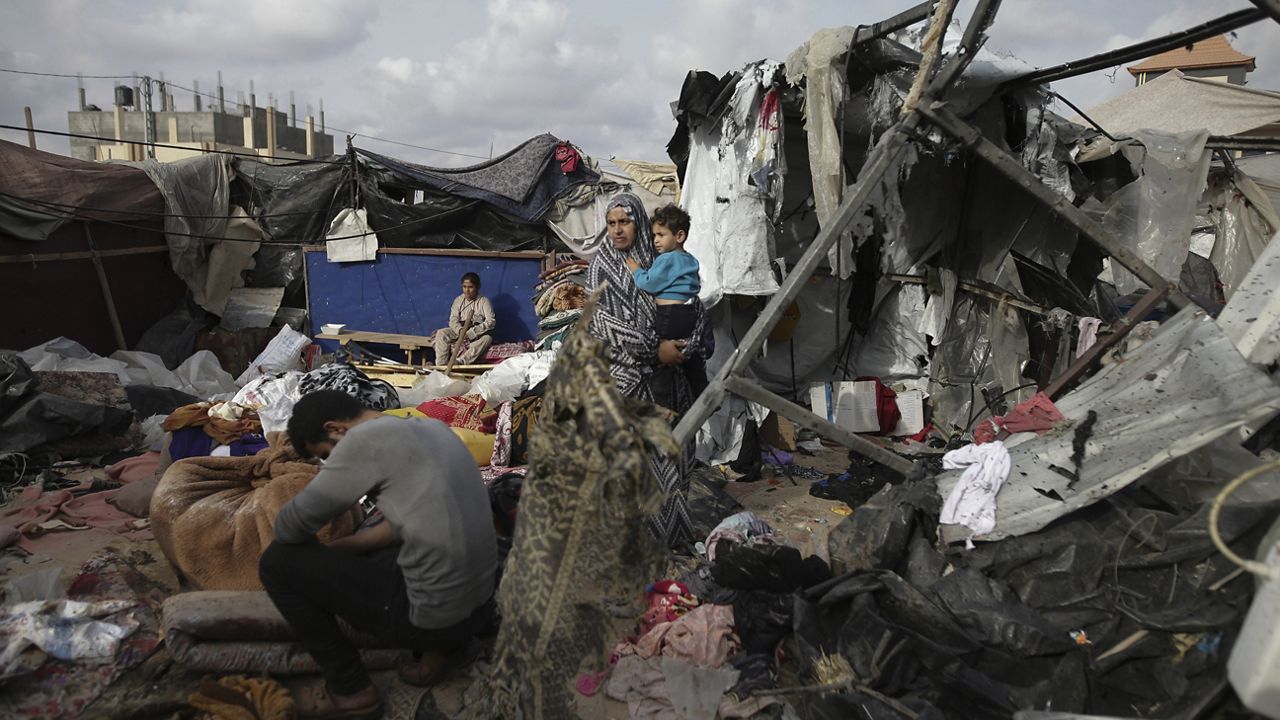 Displaced Palestinians inspect their tents destroyed by Israel's bombardment, adjunct to an UNRWA facility west of Rafah city, Gaza Strip, Tuesday, May 28, 2024. (AP Photo/Jehad Alshrafi)