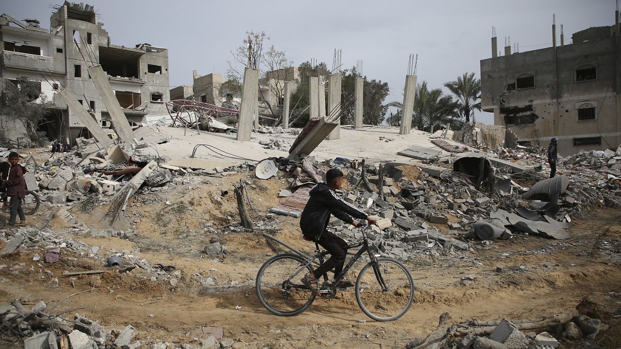 FILE - Palestinians inspect the ruins of a residential building for the Abu Muammar family after an Israeli airstrike in Rafah, southern Gaza Strip, Friday, March 29, 2024. (AP Photo/Hatem Ali)