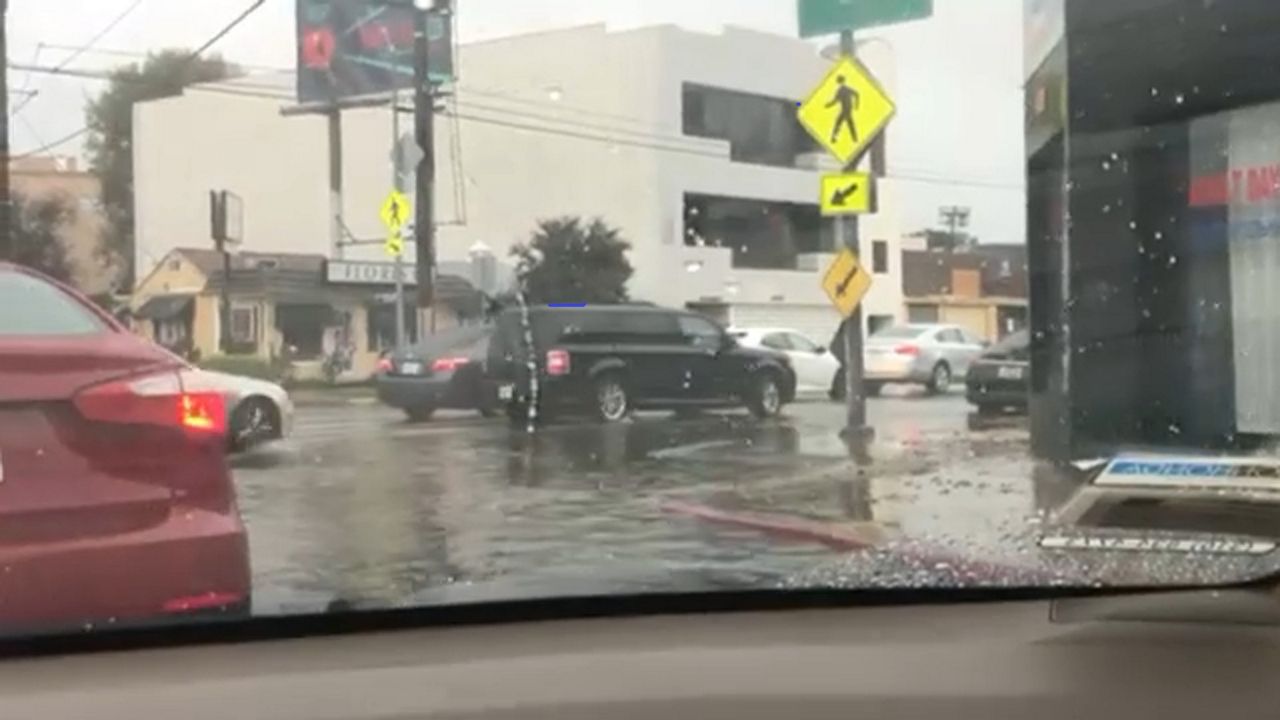 A street with cars flooded from the rains