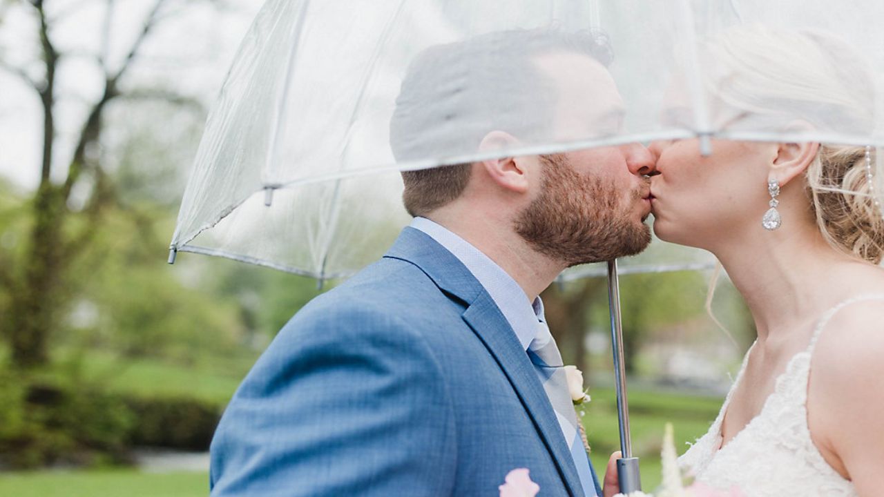 Bride and groom under umbrella