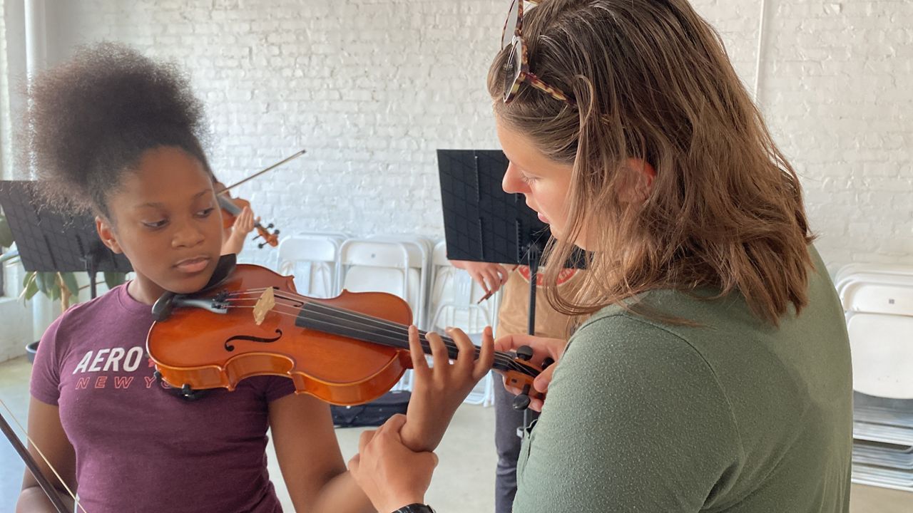 Sara Maria Blanton teaching a student at The Raleigh Music Collective.