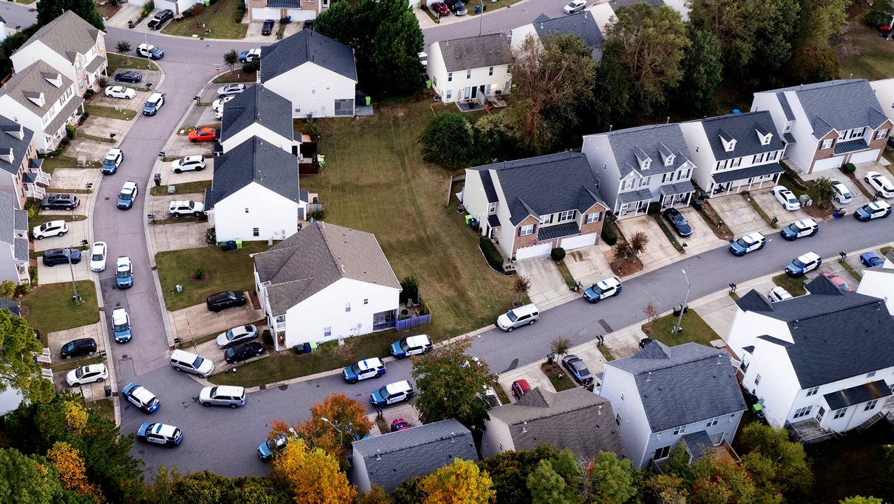 In this aerial image taken with a drone, Law enforcement work at the scene of a shooting in Raleigh, N.C., Thursday, Oct. 13, 2022. (Travis Long/The News & Observer via AP)