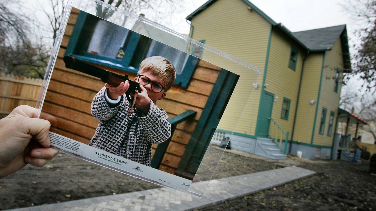 In this Nov. 13, 2006, file photo, a publicity photo of actor Peter Billingsley portraying the character Ralphie in the movie "A Christmas Story" is displayed in the backyard of the house used to film the movie's exterior shots in Cleveland. (AP Photo/Amy Sancetta, File)