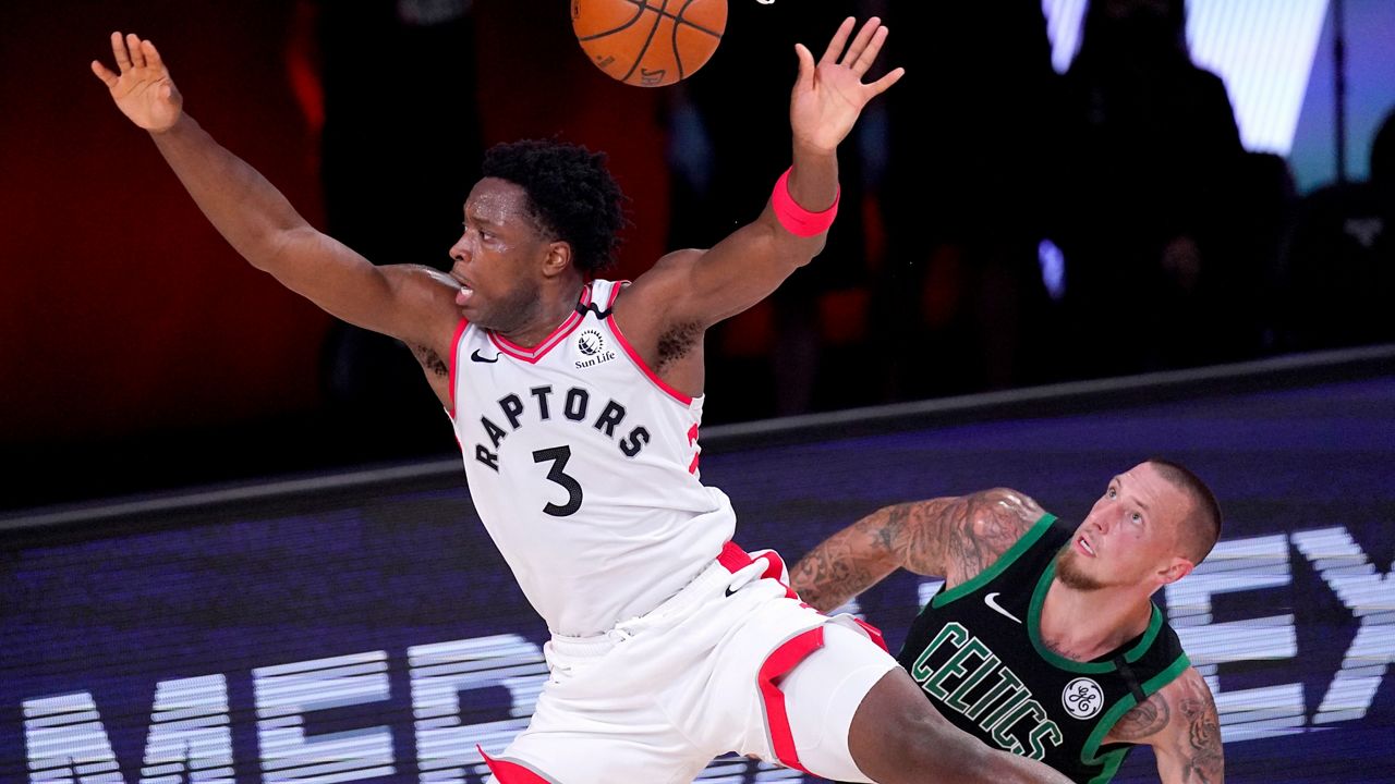Toronto Raptors' OG Anunoby (3) is fouled by Boston Celtics' Daniel Theis during the second half of an NBA conference semifinal playoff basketball game Friday, Sept. 11, 2020, in Lake Buena Vista, Fla. (AP Photo/Mark J. Terrill)