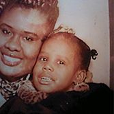 Close-up photo of Raven as a young girl with her mom to her right, cheek to cheek.