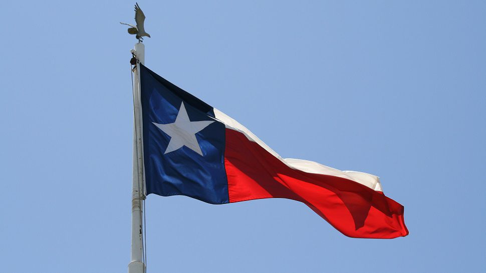 The Texas flag waves in the wind. (Photo credit: Ray Bodden)