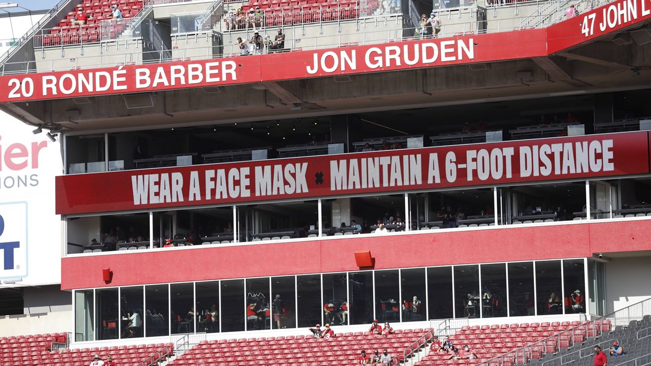 Signs that stress fans to wear a face mask are seen before a Buccaneers game at Raymond James Stadium on Oct. 18, 2020. (AP Photo/Octavio Jones, File)