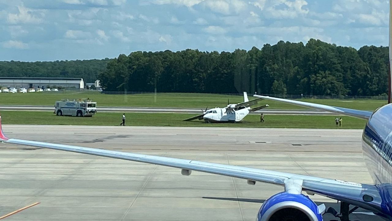 The twin-engine CASA CN-212 Aviocar reported having landing gear issues as it approached Raleigh-Durham International Airport and went off the runway and into the grass. (Photo courtesy of Simon Palmore)