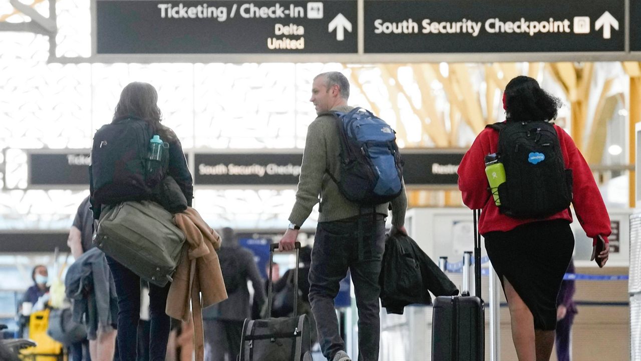 People walk through Reagan Washington National Airport in Arlington, Va., Wednesday, Nov. 22, 2023. (AP Photo/Susan Walsh, File)