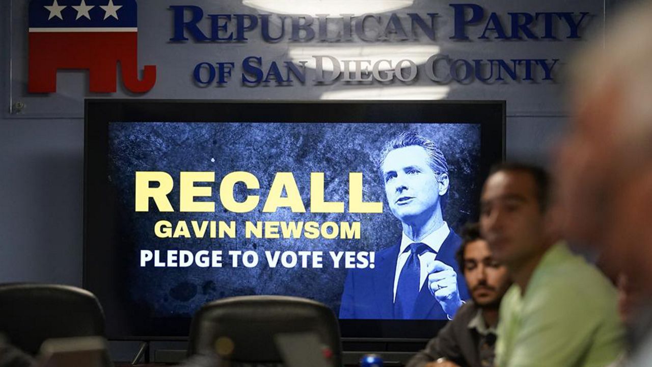 People listen during a meeting of volunteers to get out the vote by supporters of the effort to recall California Gov. Gavin Newsom at the San Diego Republican Party Headquarters, Monday, Sept. 13, 2021, in San Diego. (AP Photo/Gregory Bull)