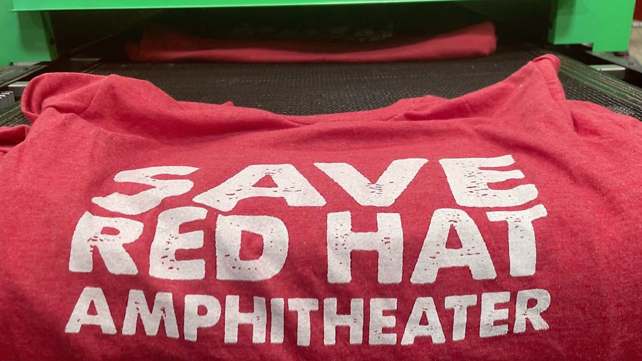 John Pugh, Co-owner of House of Swank Clothing, is making these shirts in support of moving the Red Hat Amphitheater over a block. 
