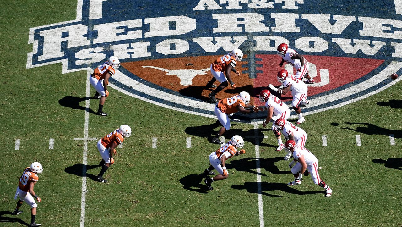 FILE - Oklahoma, right, runs a play against Texas in the first half of an NCAA college football game at the Cotton Bowl in Dallas, Oct. 12, 2019. The Big 12 is losing its marquee matchup when the Red River Rivalry is played Saturday for the final time under the league’s umbrella. (AP Photo/Jeffrey McWhorter, File)