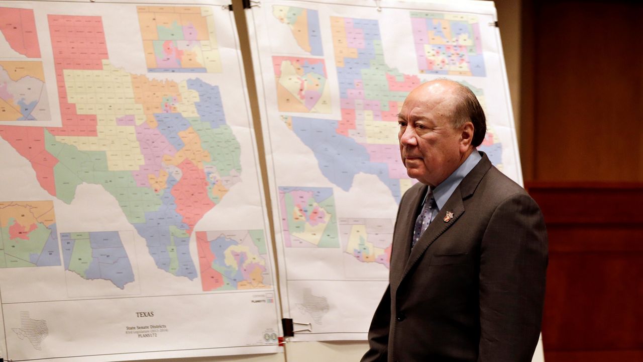Sen. Juan "Chuy" Hinojosa looks at maps on display prior to a Senate Redistricting committee hearing, Thursday, May 30, 2013, in Austin, Texas. Texas Attorney General Greg Abbott wants lawmakers to adopt the court's maps as a bid to pre-empt yet another set of maps that could further hurt Republican candidates. (AP Photo/Eric Gay)
