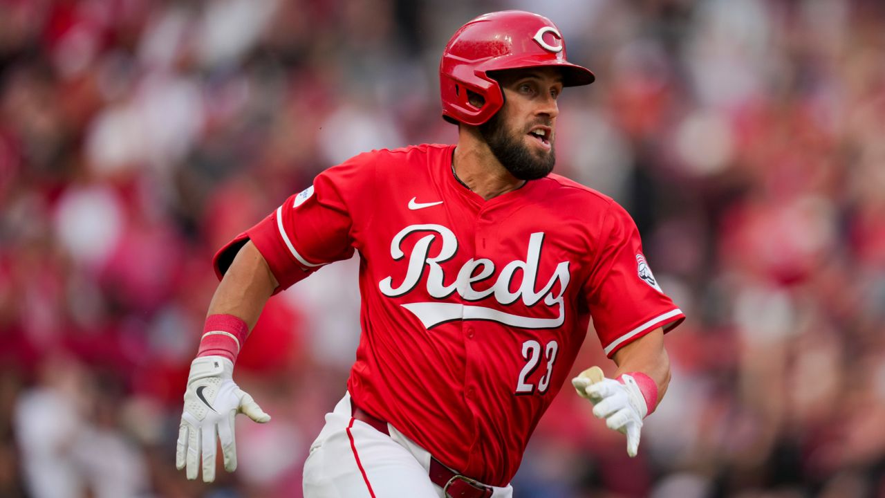 Cincinnati Reds' Nick Martini hits a two-run double during a baseball game against the Washington Nationals in Cincinnati, Saturday, March 30, 2024. 