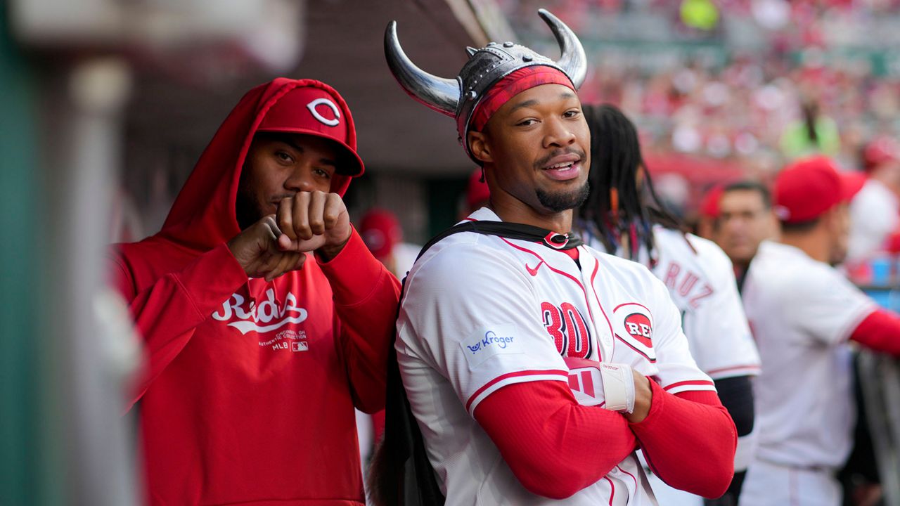 Cincinnati Reds' Will Benson, right, poses for a photo with Hunter Greene, left, after hitting a solo home run during the second inning of a baseball game against the Milwaukee Brewers in Cincinnati, Monday, April 8, 2024. (AP Photo/Aaron Doster)