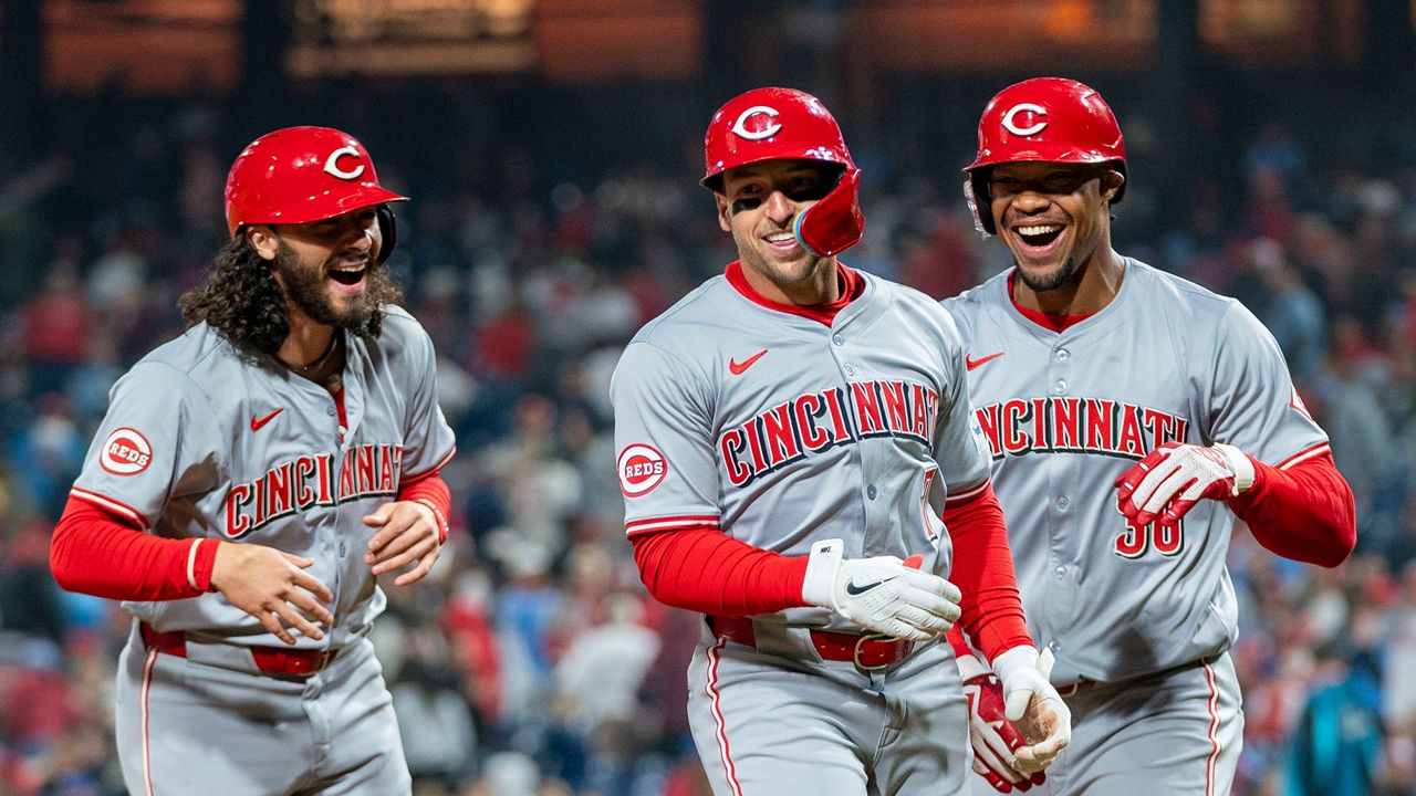 Cincinnati Reds' Spencer Steer, center, celebrates his grand slam with Jonathan India, left, and Will Benson during the tenth inning of a baseball game against the Philadelphia Phillies, Monday, April 1, 2024, in Philadelphia. (AP Photo/Chris Szagola)