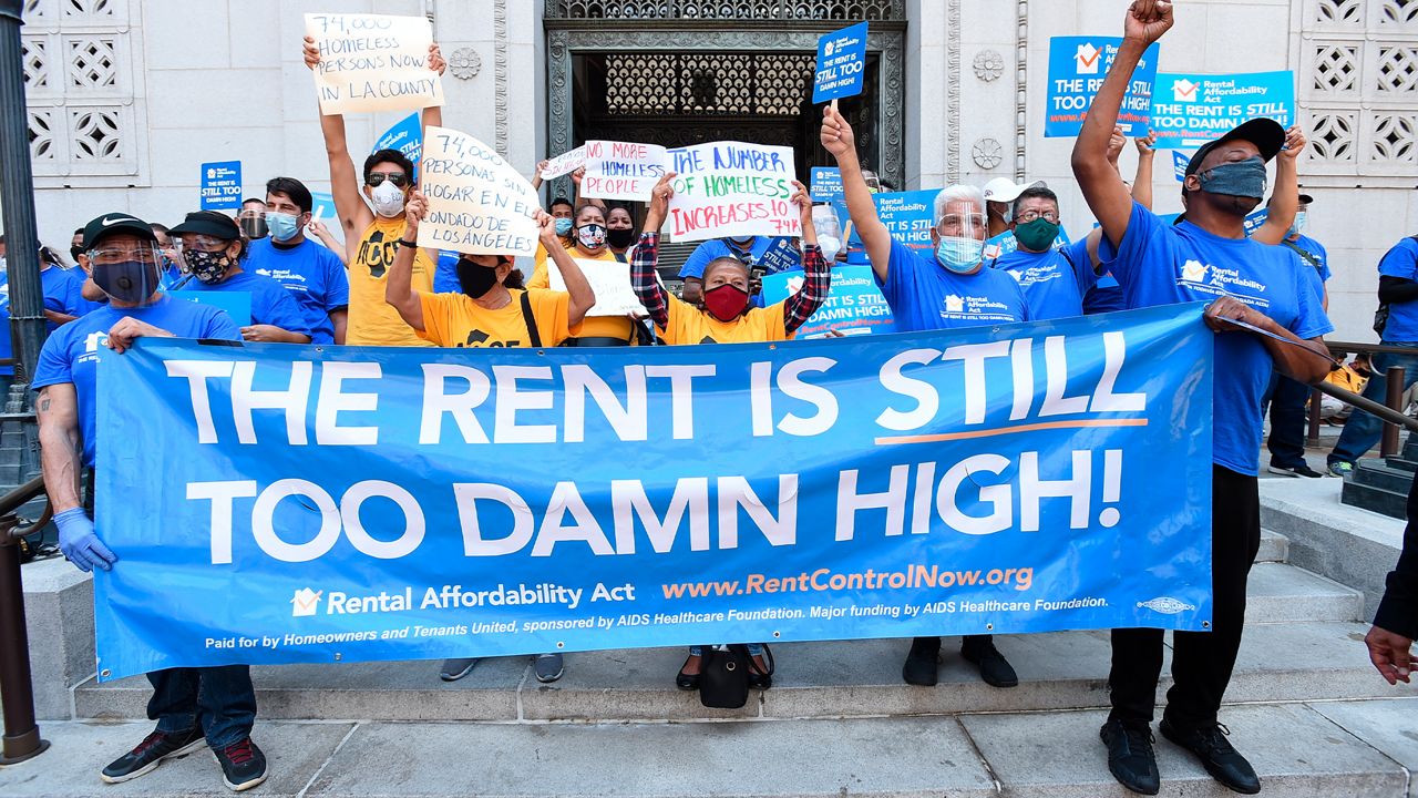 IMAGE DISTRIBUTED FOR AIDS HEALTHCARE FOUNDATION - Housing justice advocates and mobilizers with the Rental Affordability Act share their rallying cry that 'The Rent is Too Damn High!" at a press conference urging the County and City of Los Angeles to undertake radical new thinking and approaches on housing the homeless.  (Jordan Strauss/AP Images for AIDS Healthcare Foundation)