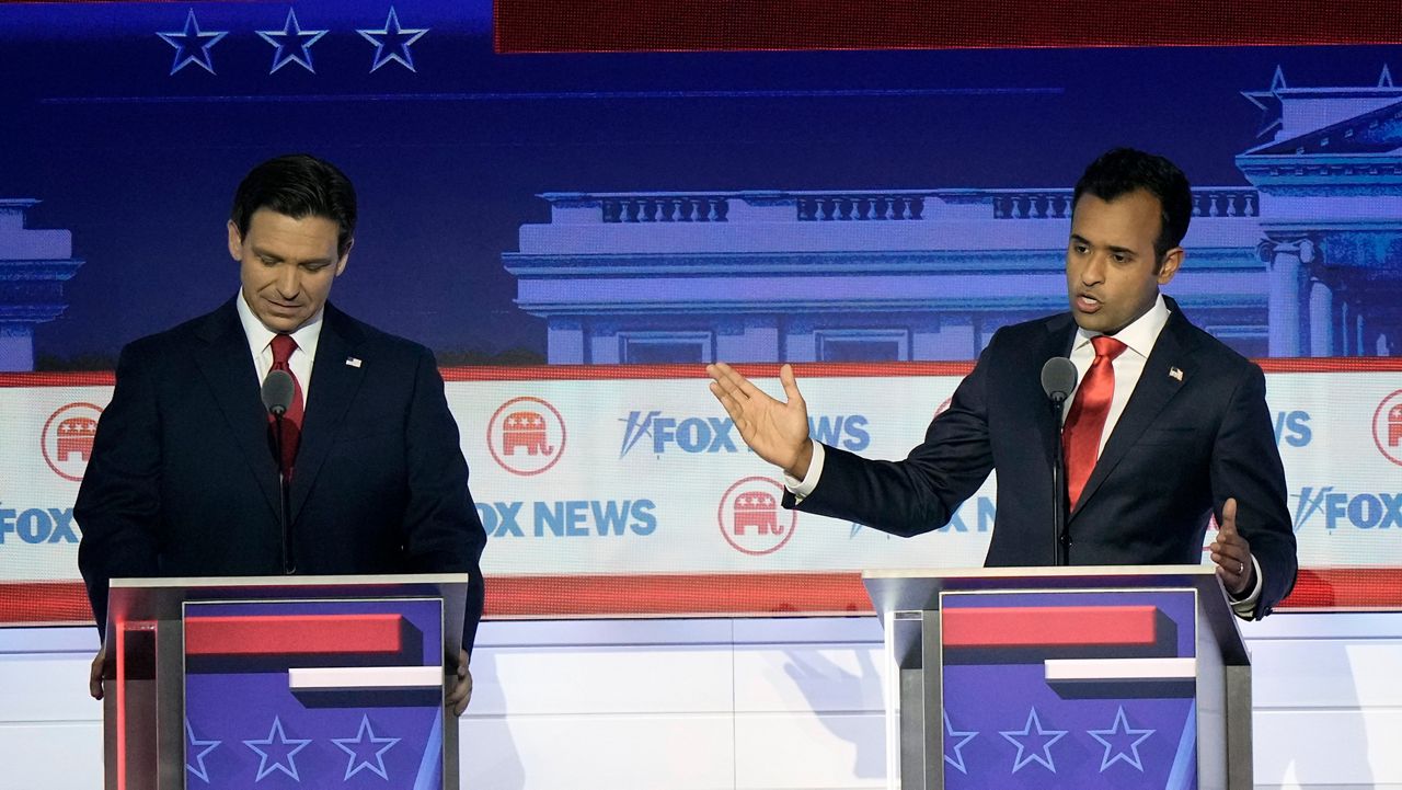 Vivek Ramaswamy speaks as Ron DeSantis listens during a Republican presidential primary debate on Wednesday, Aug. 23, 2023 in Milwaukee.