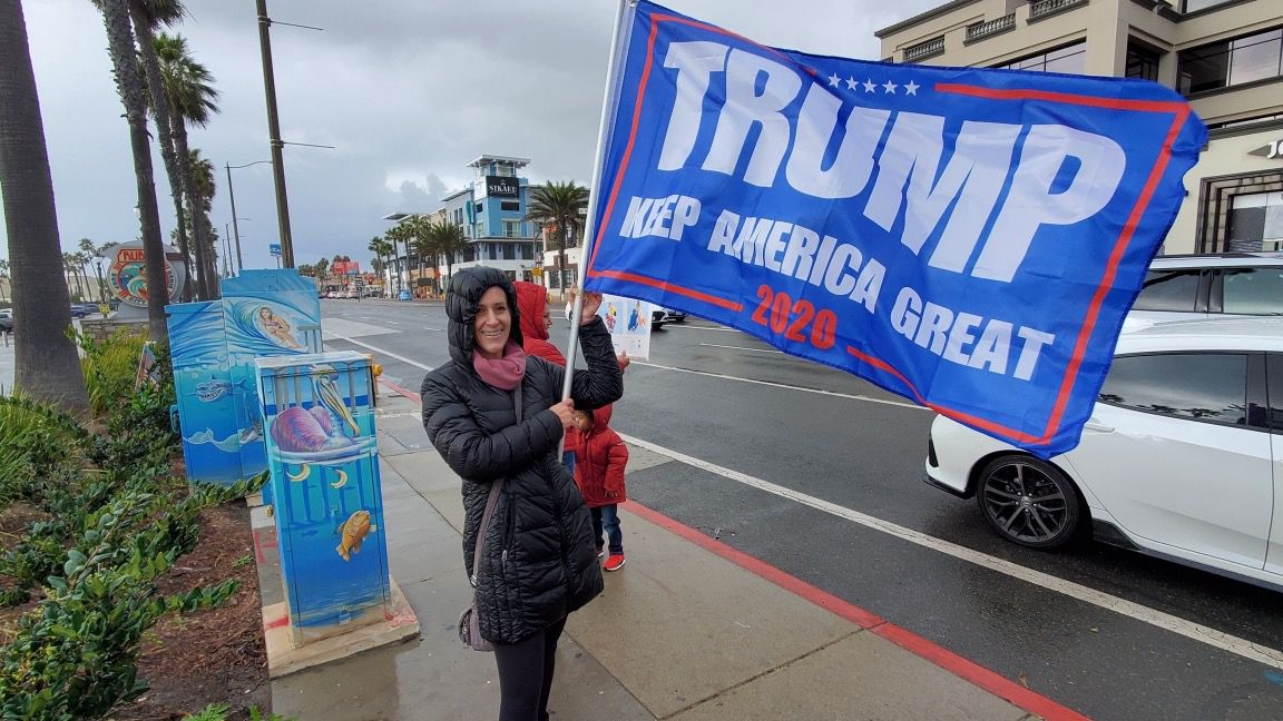Hillary Green stood in the rain to make her voice heard Saturday, Nov. 7, 2020 in Huntington Beach, Calif. (Spectrum News 1/Joseph Pimentel)