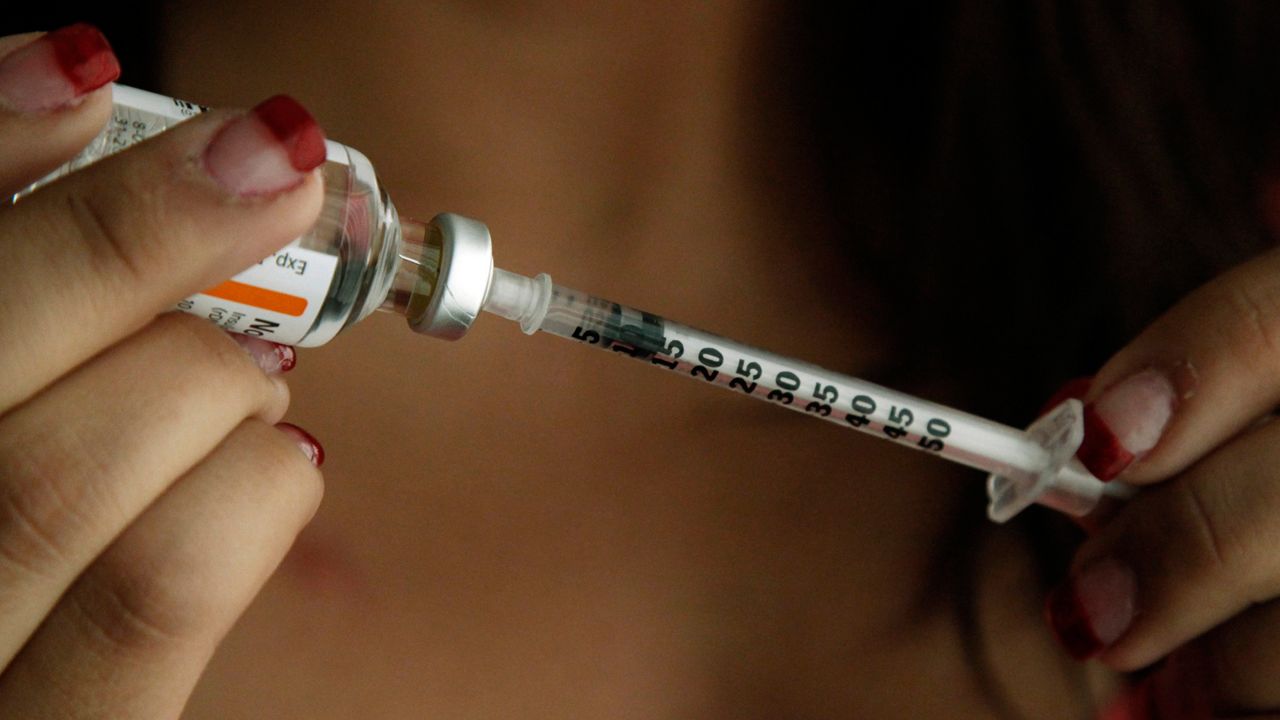 Judith Garcia, 19, fills a syringe as she prepares to give herself an injection of insulin at her home in the Los Angeles suburb of Commerce, Calif., Sunday, April 29, 2012. (AP Photo/Reed Saxon)