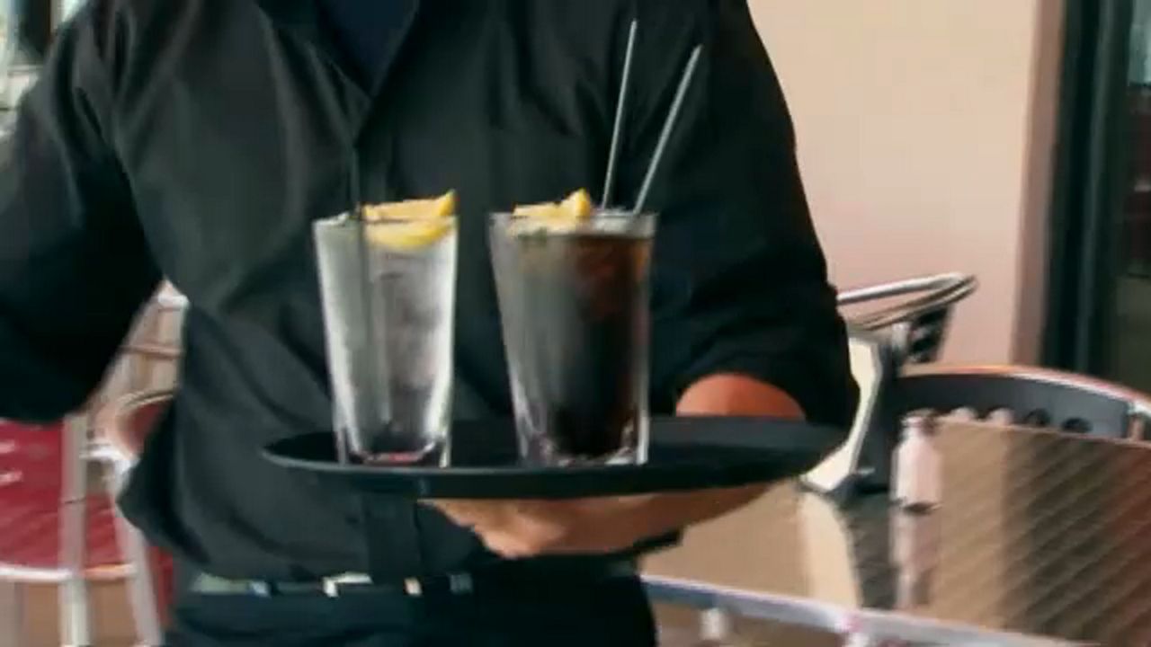 Waiter holds drinks