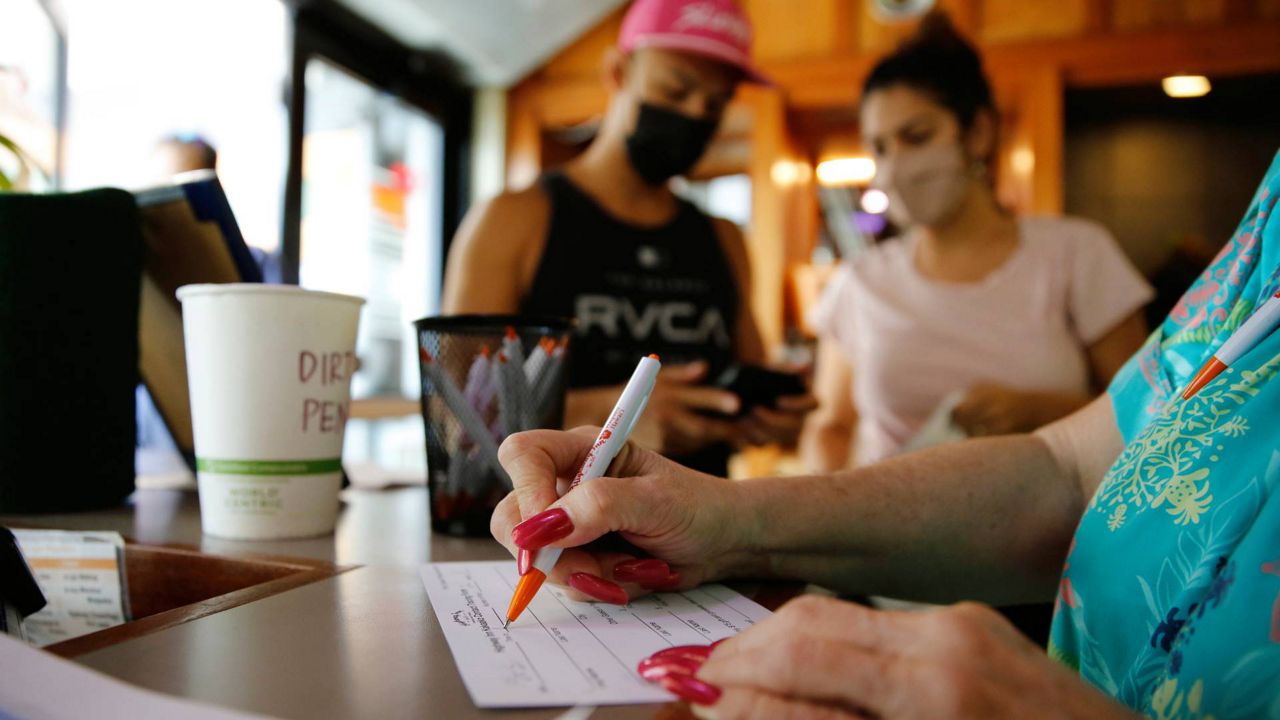 As of Monday, Feb. 21, patrons will no longer need to show proof of vaccination for indoor service at restaurants, bars or gyms in Maui County. (AP Photo/Caleb Jones)