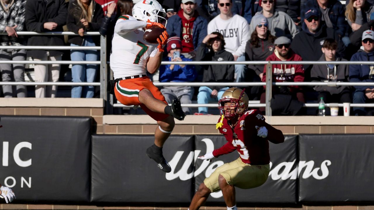 Boston College defensive back Khari Johnson (3) watches as Miami wide receiver Xavier Restrepo (7) connects on a pass near the end zone during the first half of an NCAA college football game Friday, Nov. 24, 2023 in Boston. (AP Photo/Mark Stockwell)