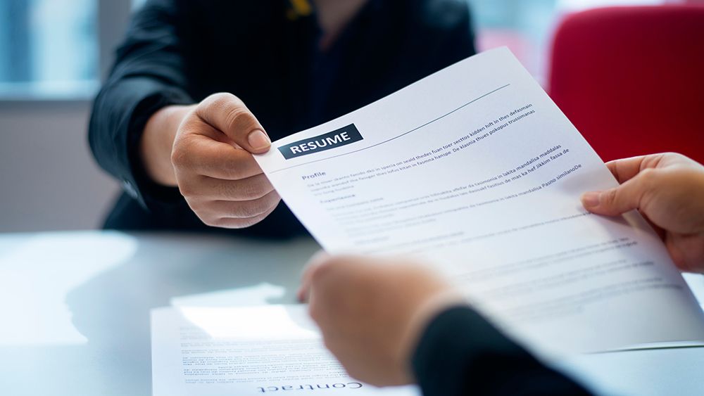 A person holding a resume (Getty Images)