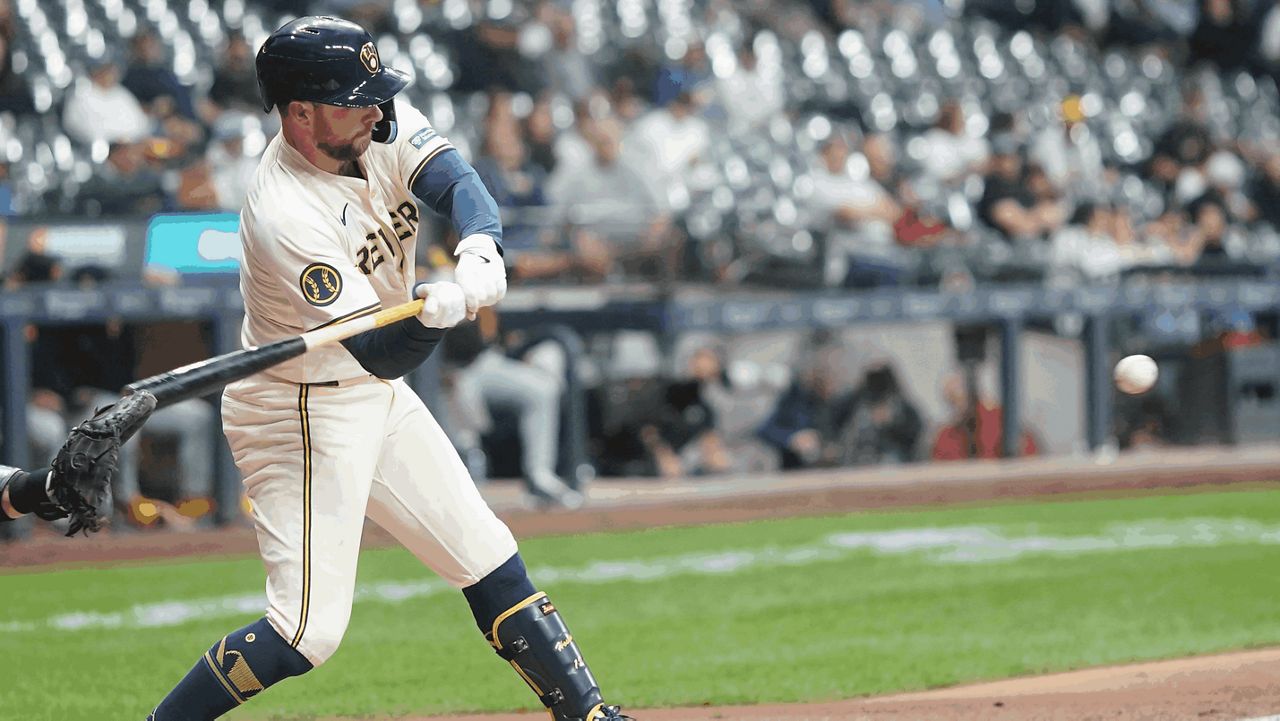 Milwaukee Brewers' Rhys Hoskins hits a single during the second inning of a baseball game 