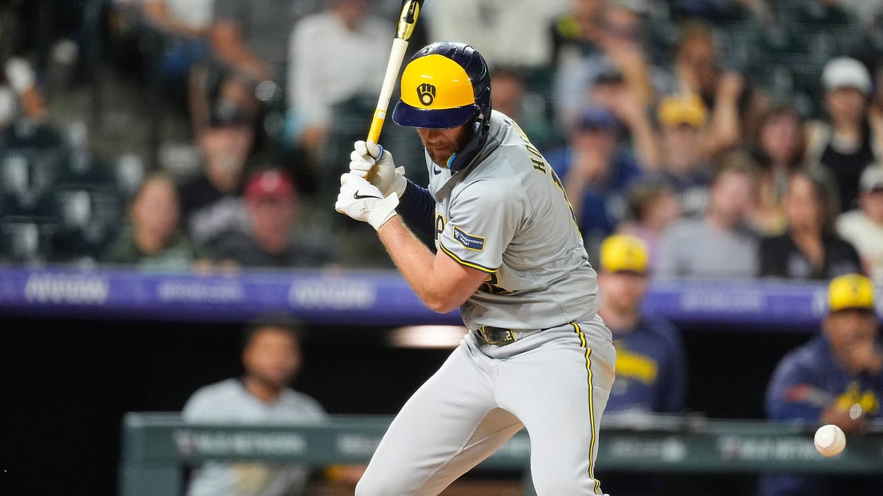 The ball bounces off Milwaukee Brewers' Rhys Hoskins 