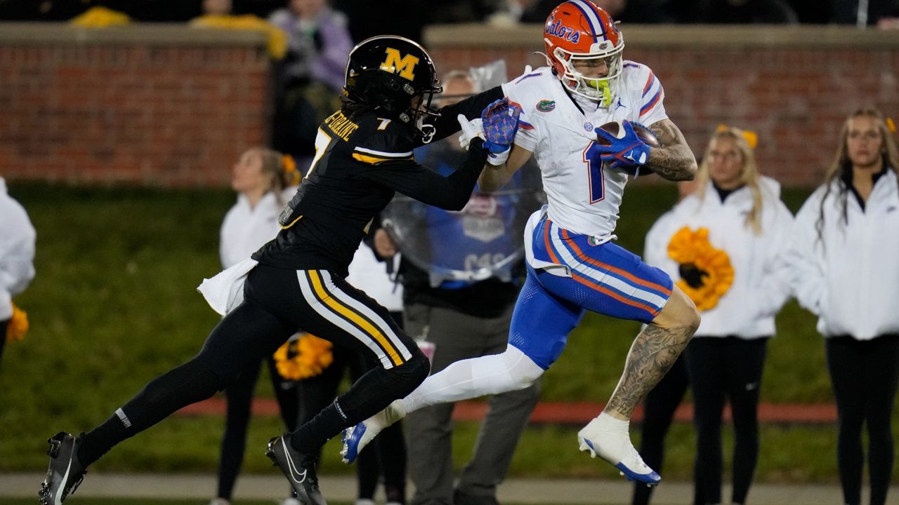 Florida wide receiver Ricky Pearsall (1) scores past Missouri defensive back Kris Abrams-Draine during the second half of an NCAA college football game Saturday, Nov. 18, 2023, in Columbia, Mo. Missouri won 33-31. (AP Photo/Jeff Roberson)