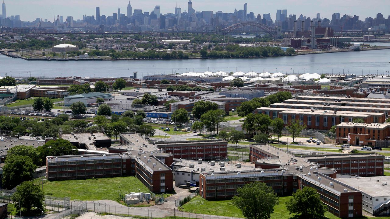 The Rikers Island jail complex stands in New York with the Manhattan skyline in the background on June 20, 2014.