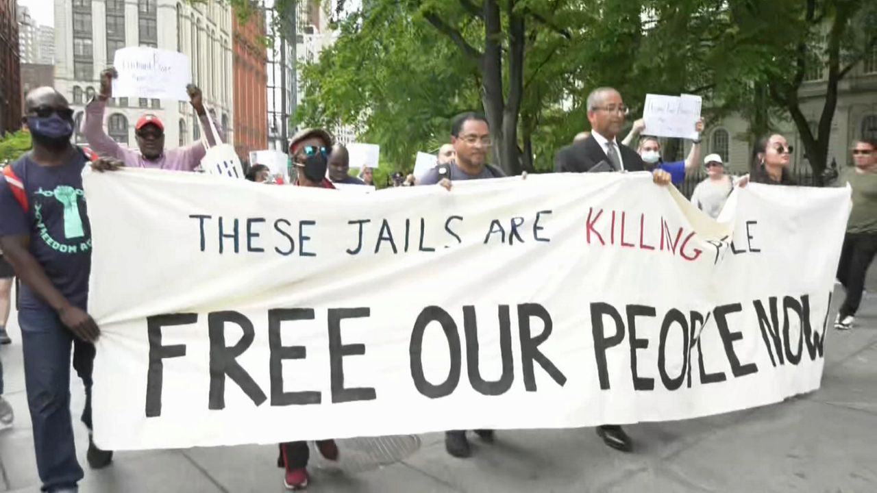 Protestors march to City Hall Tuesday, as the city filed its action plan to reform Rikers Island in an attempt to avoid a federal takeover. (NY1 Photo)