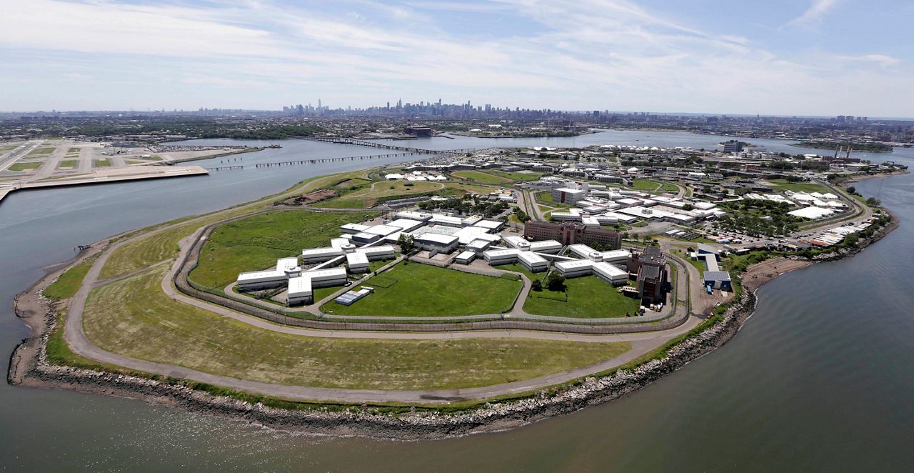 The Rikers Island jail complex is seen with LaGuardia Airport and the Manhattan skyline on June 20, 2014.