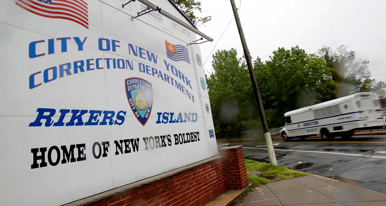 Rikers Island sign and Department of Correction bus