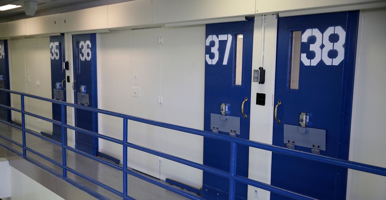 In this March 12, 2015 file photo, numbered doors of enhanced supervision housing unit, also commonly known as solitary confinement, are shown at the Rikers Island jail complex n New York. (AP Photo/Seth Wenig, File)