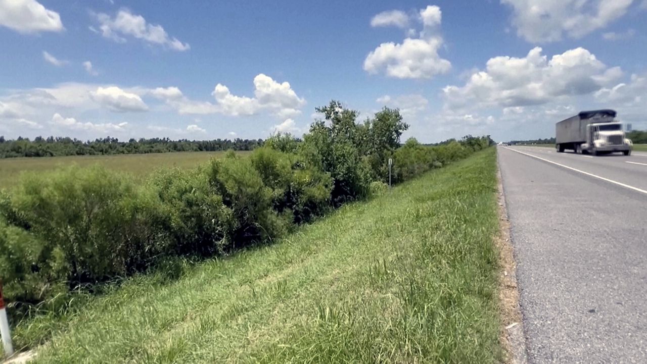 This image made from video provided by KPLC shows a truck passing along the highway where a 1-year-old child was found on Tuesday, July 9, 2024. (KPLC via AP)