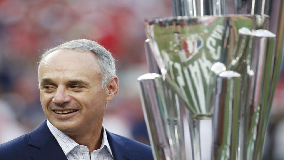 Major League Baseball Commissioner Rob Manfred stands with trophy before the MLB Home Run Derby, at Nationals Park, Monday, July 16, 2018 in Washington. The 89th MLB baseball All-Star Game will be played Tuesday. (AP Photo/Alex Brandon)