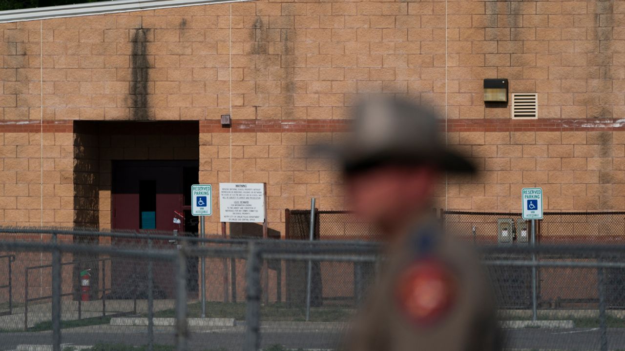 A back door at Robb Elementary School, where a gunman entered through to get into a classroom in last week's shooting, is seen in the distance in Uvalde, Texas, Monday, May 30, 2022. (AP Photo/Jae C. Hong, File)