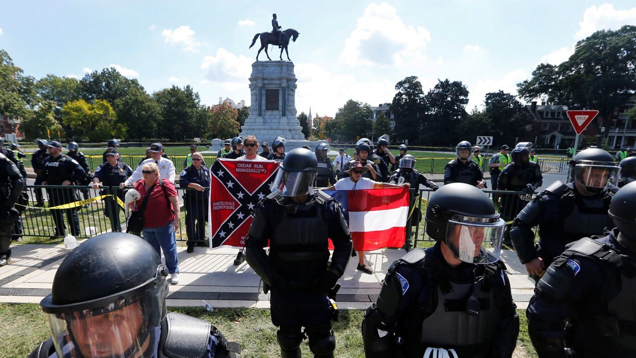 In this 2017 photo, police stand guard outside the Robert E. Lee monument in Charlottesville, Va., seeking to thwart any violence one year after the deadly "Unite the Right" rally. (AP)