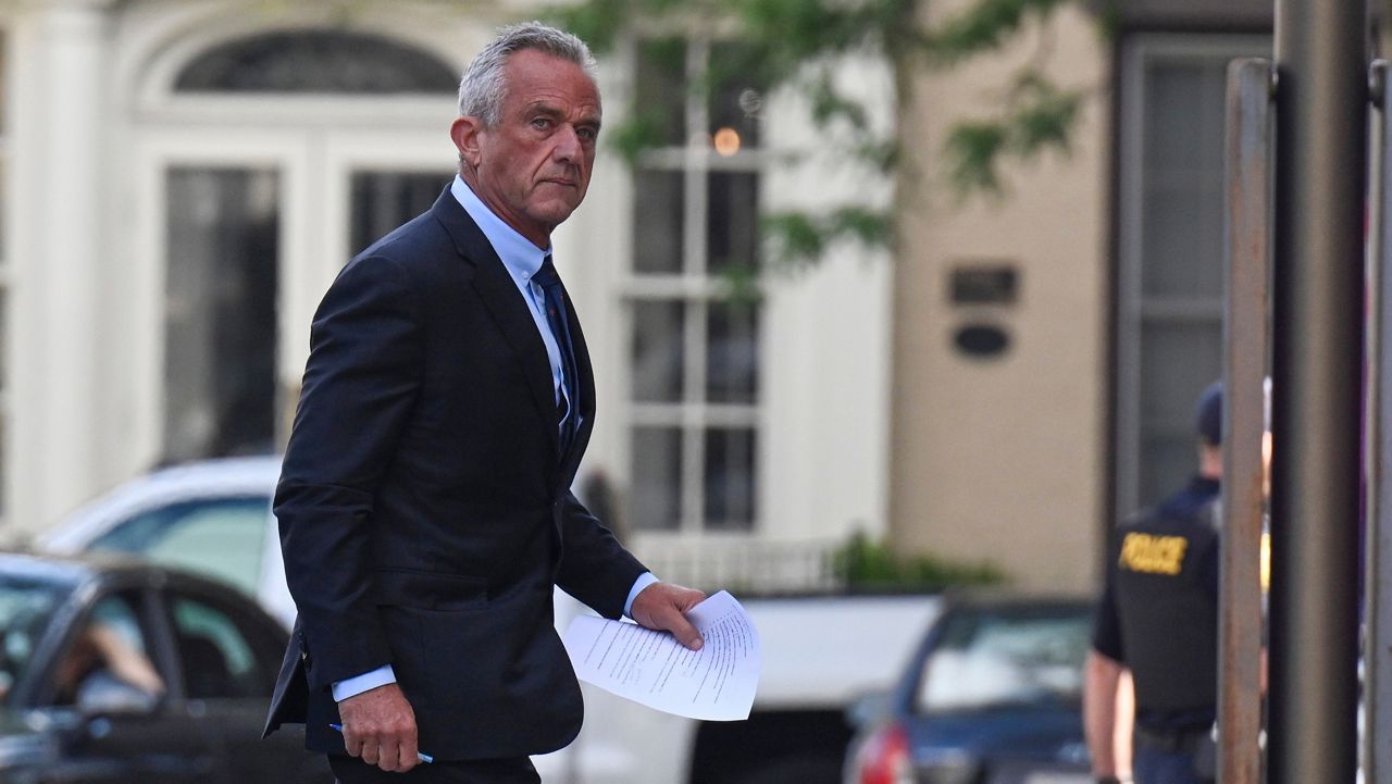 Independent presidential candidate Robert F. Kennedy Jr., right, arrives at the Albany County Courthouse to fight a lawsuit he falsely claimed to live in New York state, Wednesday, Aug. 7, 2024, in Albany, N.Y. (AP Photo/Hans Pennink)