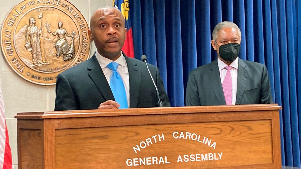 House Minority Leader Robert Reives, left, D-Chatham, speaks while Senate Minority Leader Dan Blue, D-Wake, listens at a news conference at the Legislative Building in Raleigh, N.C., Monday, Feb. 7, 2022. Reives and Blue spoke about a redistricting ruling by the state Supreme Court that struck down General Assembly and congressional maps approved by the legislature in November. (AP Photo/Gary D. Robertson)