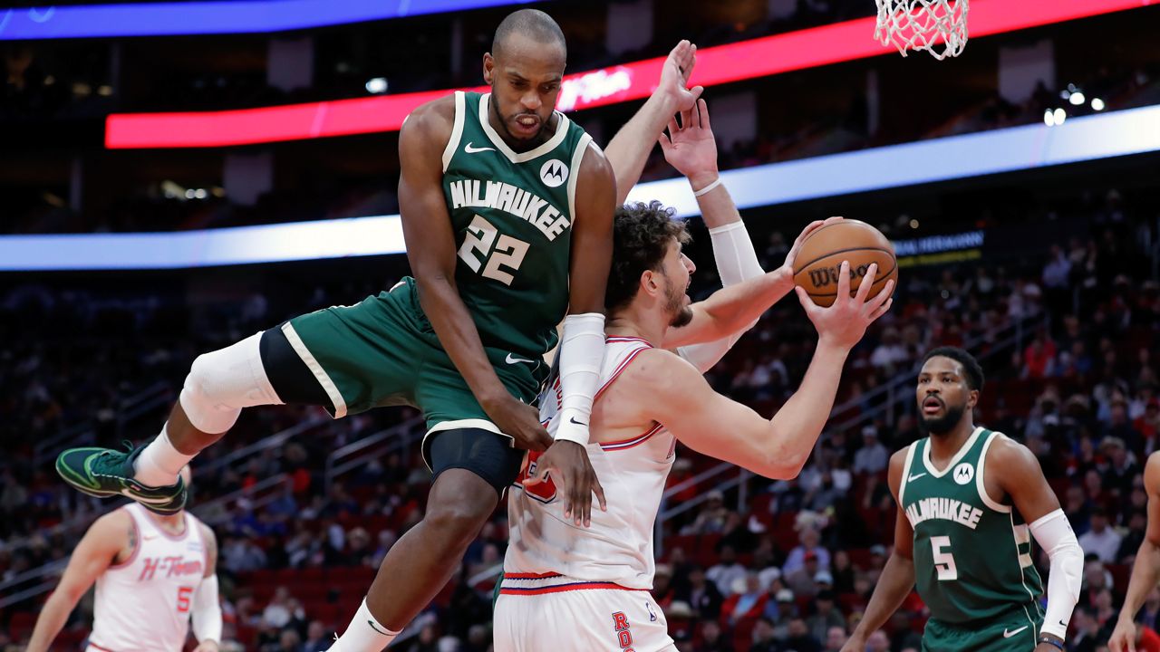 Milwaukee Bucks forward Khris Middleton (22) fouls Houston Rockets center Alperen Sengun