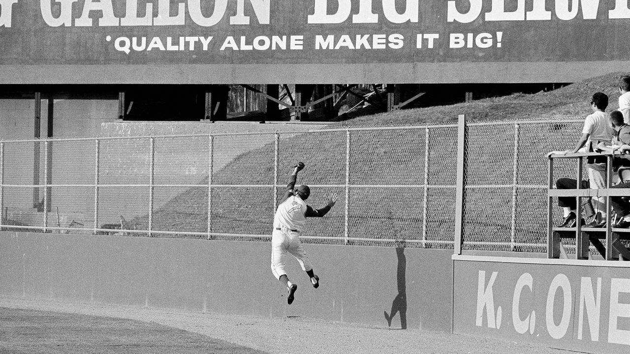  Kansas City's right fielder Rocky Colavito makes a running, leaping backhand catch of a fly ball by Minnesota's Bernie Allen in the eighth inning at Kansas City, Mo., May 3, 1964. (AP Photo/William P. Straeter, File)