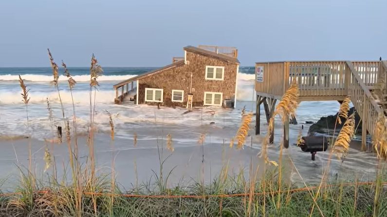 A video posted to social media Friday by Chicamacomico Banks Fire & Rescue shows the two-story house floating in the surf. (Chicamacomico Banks Fire & Rescue)